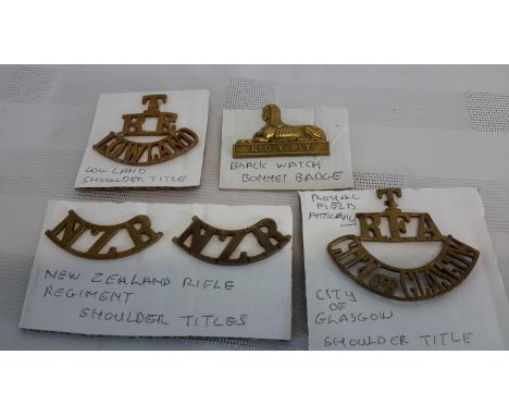 3 various title badges 'Lowland', 'New Zealand Rifle' & 'Royal Field Artillery', together with Black Watch bonnet badge 