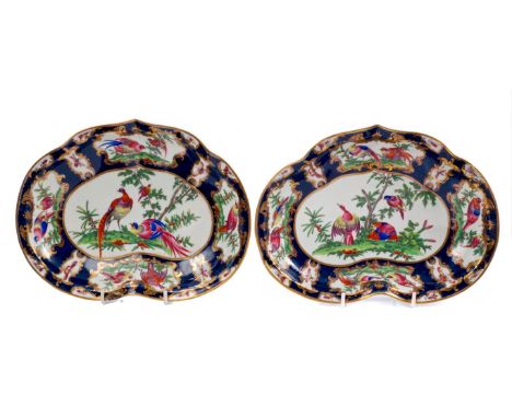 Two 18th century Worcester kidney-shaped dessert dishes, finely polychrome painted with exotic birds and insects within gilt 