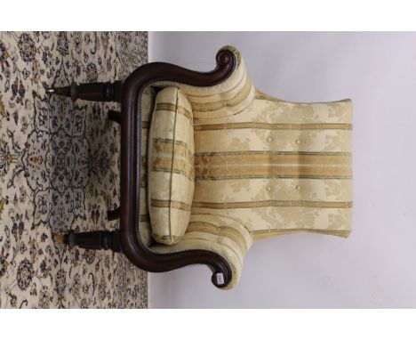 William IV mahogany button back tub library chair with show wood moulded frame, raised on faceted turned supports terminating