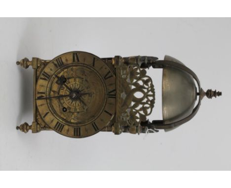 17th century and later lantern clock of traditional form with bell cage above, engraved dolphin crestings, broad circular dia