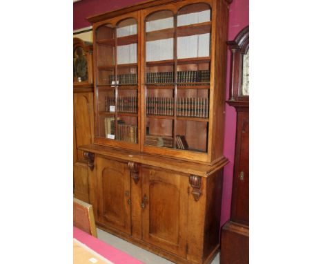 Late Victorian mahogany bookcase cabinet, the upper section with ogee-moulded cornice and adjustable shelves enclosed by a pa