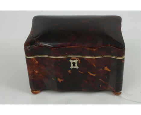 Victorian tortoiseshell tea caddy of undulating rectangular form, with lidded compartments, on bun feet, 14cm wide x 10cm hig
