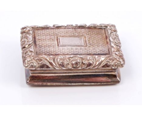 George IV silver vinaigrette of rectangular form, with engine-turned decoration and raised foliate border, hinged cover with 