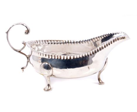 Late 18th century Cork Irish silver sauce boat of typical form, with crimped border and open scroll handle, on three hoof fee