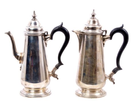 George V silver coffee pot of tapering baluster form, with faceted spout and ebony scroll handle, hinged domed and stepped co