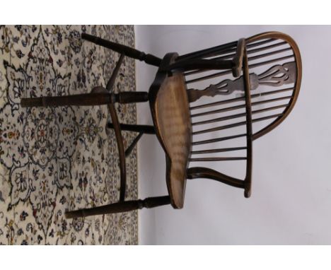 Early 19th century oak, elm and beech stick back elbow chair with pierced vase-shaped splat and shaped solid seat, on turned 