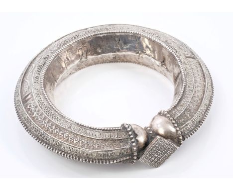 Antique Indian white metal bangle with applied and repoussé decoration, 11.5cm diameter