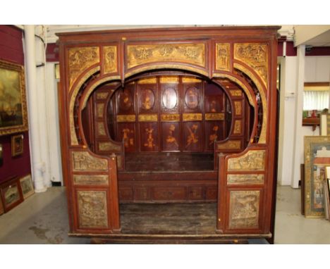 Impressive 19th century Chinese carved and pierced hardwood red and painted lacquer and gilt heightened canopy bed with integ
