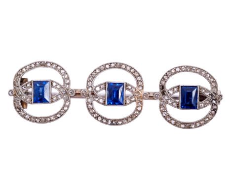 Art Deco French sapphire and diamond plaque brooch, by Janesich, with three open work plaques, each centred with a step cut b