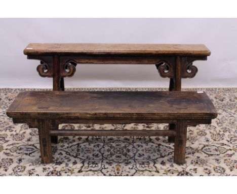 Two antique Chinese elm benches, the largest with solid top on scroll carved frieze and splayed supports, 128cm and 115cm wid