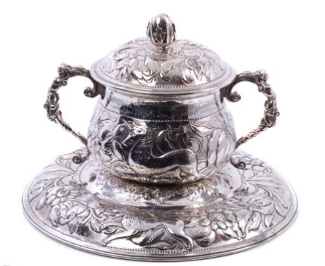 Antique silver caudle cup and cover of typical form, with repoussé lion, unicorn and floral decoration and twin caryatid hand
