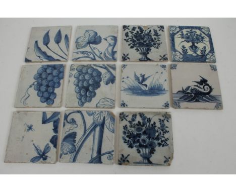 Eleven 18th century Dutch Delft tin glazed blue and white tiles painted with flora, insects and birds, etc, 15.5cm square CON