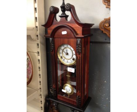 A CHIMING WALL CLOCK, LENGTH 64CM. R