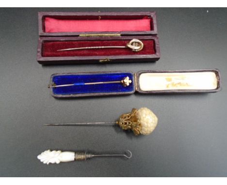 3 Hat/stick pins, 2 are boxed and possibly 9ct gold although not tested or hallmarked, plus a button hook with a mother of pe