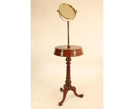 A VICTORIAN MAHOGANY SHAVING STAND, stamped Heal & Son, London, the brass framed circular mirror on turned stem, moulded circ