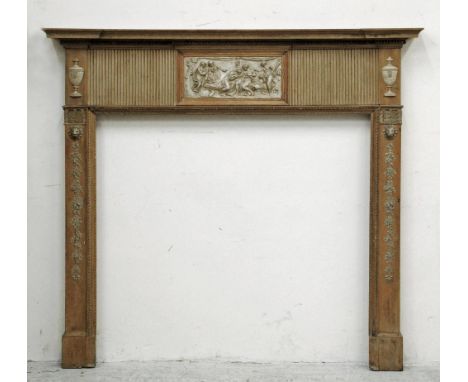 A GEORGIAN PINE AND GESSO CHIMNEY PIECE, late 18th century, the inverted breakfront shelf with lambrequin edging, fluted frie