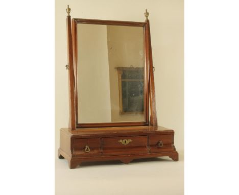 A GEORGIAN MAHOGANY TOILET MIRROR, 18th century, the oblong plate on square tapering supports with brass urn finials, oblong 