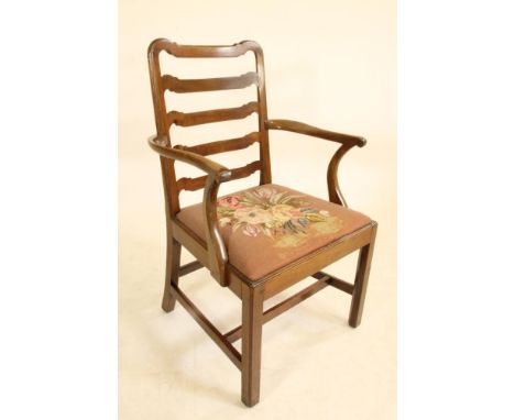 A GEORGIAN MAHOGANY LADDER BACK ELBOW CHAIR, third quarter 18th century, the channelled frame with dished top rail, four wave