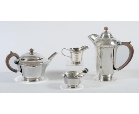 AN ARTS AND CRAFTS FIVE PIECE SILVER TEA SERVICE, maker Liberty & Co., Birmingham 1912 (teapot and tongs) and 1913, of rounde