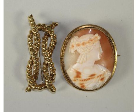 A VICTORIAN SHELL CAMEO BROOCH of oval form carved with the bust portrait of a young lady wearing a wreath in her ringlets, i