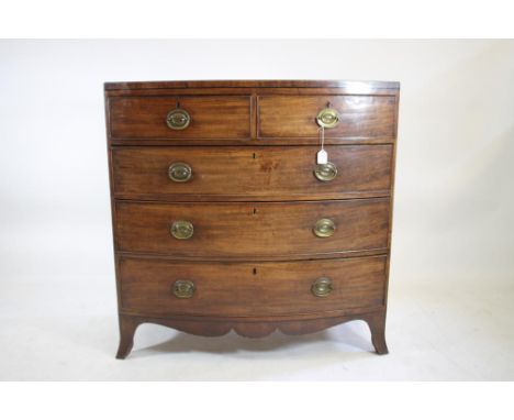 A REGENCY MAHOGANY CHEST, early 19th century, of bowed form with ebony stringing, the caddy top over two short and three long