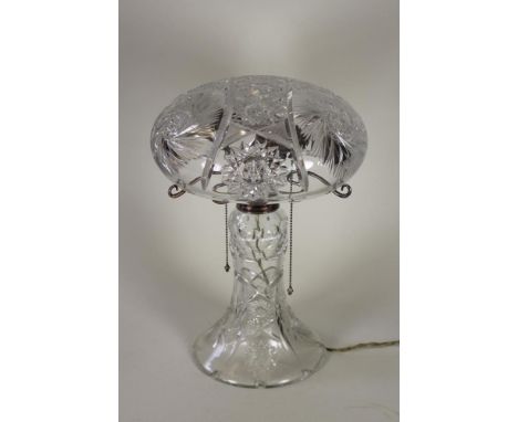 A GLASS TABLE LAMP BASE, c.1930's, the star and slice cut mushroom shade supported on three EPNS scroll branches with origina