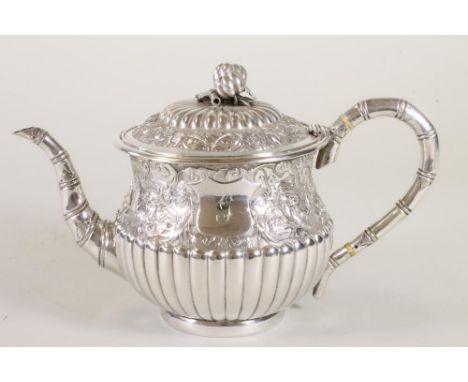 A CHINESE SILVER TEAPOT, maker's mark WS (W O Shing, Shanghai?), of semi fluted baluster form, the upper section chased with 