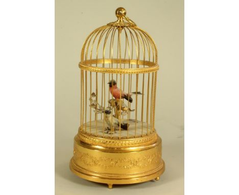 A REUGE SINGING BIRD AUTOMATON, mid 20th century, the domed gilt metal cage with ring handle enclosing two singing birds with