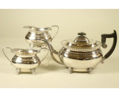 A THREE PIECE SILVER TEA SERVICE, makers Viners, Sheffield 1942, of rounded oblong baluster form with bobbin cast rims and ra