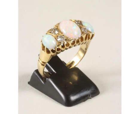 AN OPAL AND DIAMOND RING, the three oval cabochon polished opals interspersed with four old cut diamonds to plain 18ct gold s