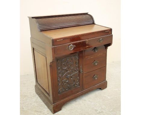 A MAHOGANY "BRADFORD DESK" by Christopher Pratt & Sons, early 20th century, the frieze drawer operating a tambour fronted top