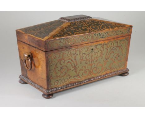 A REGENCY ROSEWOOD TEA CADDY of sarcophagus form with ring handles and raised upon four bun feet, the hinged cover and fascia