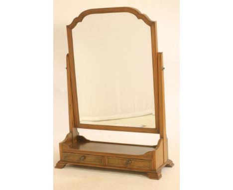 A LARGE MAHOGANY TOILET MIRROR, c.1900, of oblong form crossbanded with ebony stringing, arched bevelled plate on channelled 