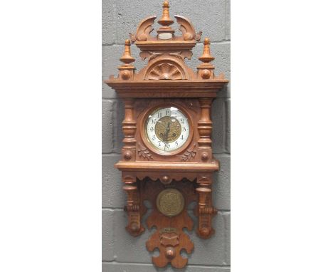 A carved oak wall clock circa 1900,105cm high