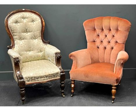 A Victorian spoon back armchair together with another button back armchair upholstered in pink velvet on turned front legs (2