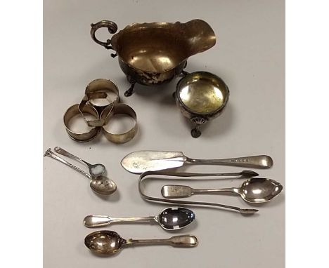 A collection of silverware including napkin rings, sauce boat, flatware, cauldron salt and a weighted capstan inkwell etc. 39