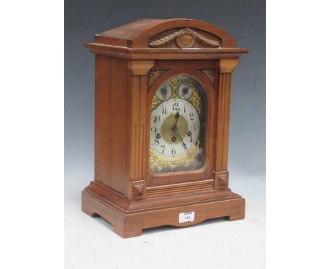 An Edwardian walnut case gong chiming mantel clock with arch top above chime/silent and slow/fast dials. 45cm x 30cm x 23cm