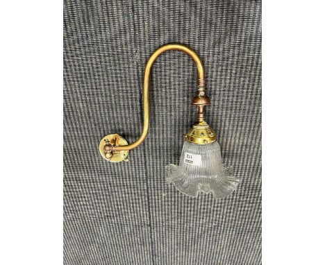 A Victorian brass and glass gas wall light, of swan neck form and moulded shade (adapted for electricity) stamped W.W.E.G Co 