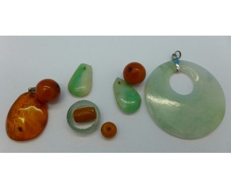 A large jade pendant, an amber coloured pendant, a jade ring, etc.