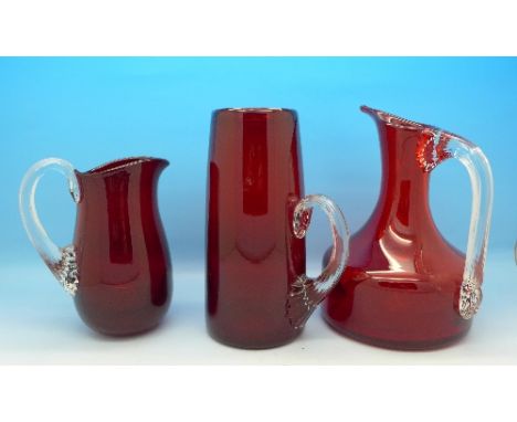 Three Whitefriars 1960's ruby red jugs with ribbed handles, pattern Nos 9718, 9419 and 9504 height of largest 15cm