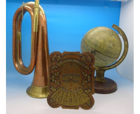 A brass and copper bugle, a small terrestrial globe and a brass 1943-1970 calendar