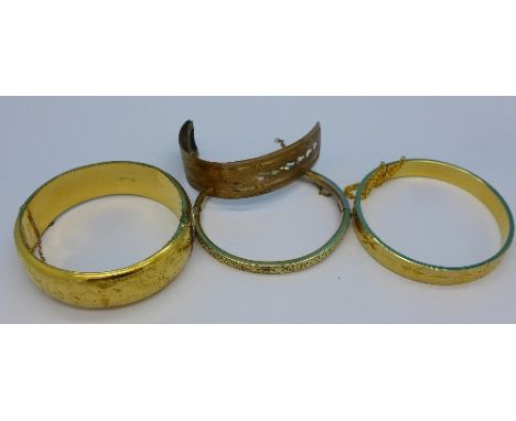 Three bangles, one marked 9ct gold metal core, and one part bangle
