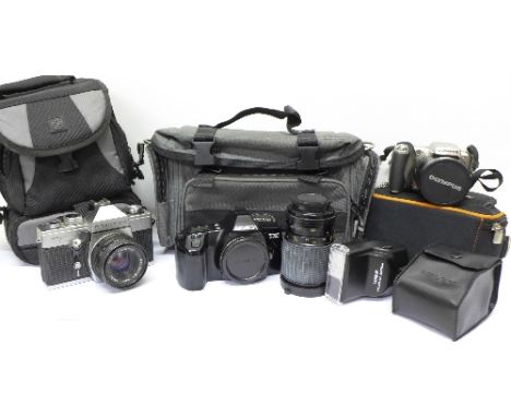 An Olympus digital camera, a Praktica MTL camera with flash, lens, a Minolta Dynax 3000i camera, and a Canon A5-6 waterproof 