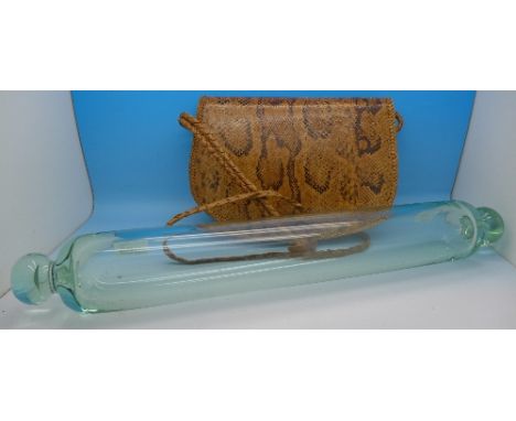 An early 20th Century glass rolling pin and a snakeskin handbag