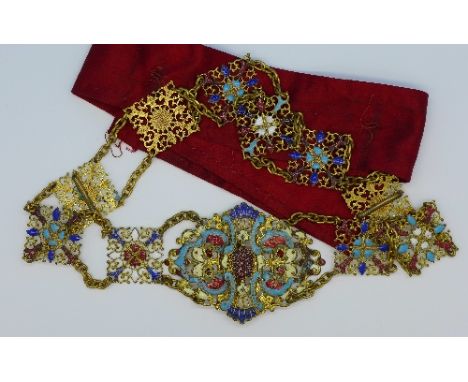 A gilt and enamel belt, 64cm