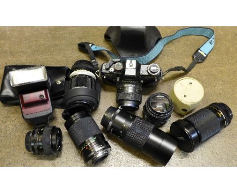 A Praktica BC1 camera, six spare lenses, flash guns, lenses, etc.