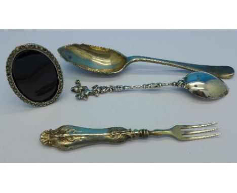 A small sterling silver and marcasite frame, two spoons and a pickle fork