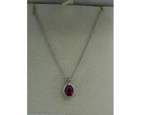 A 9ct white gold, ruby and diamond pendant on an 18ct white gold chain