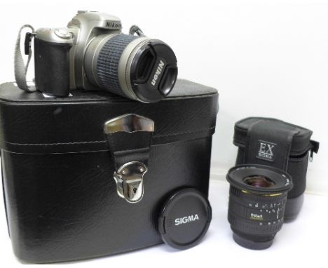 A Nikon F55 film camera with 28-100mm lens, instructions, cased, and an associated Sigma 17-35mm spherical lens