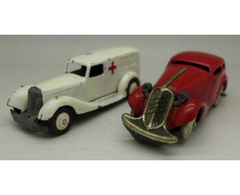 A red Schuco clockwork tin plate car, no key, and a Dinky Toys ambulance